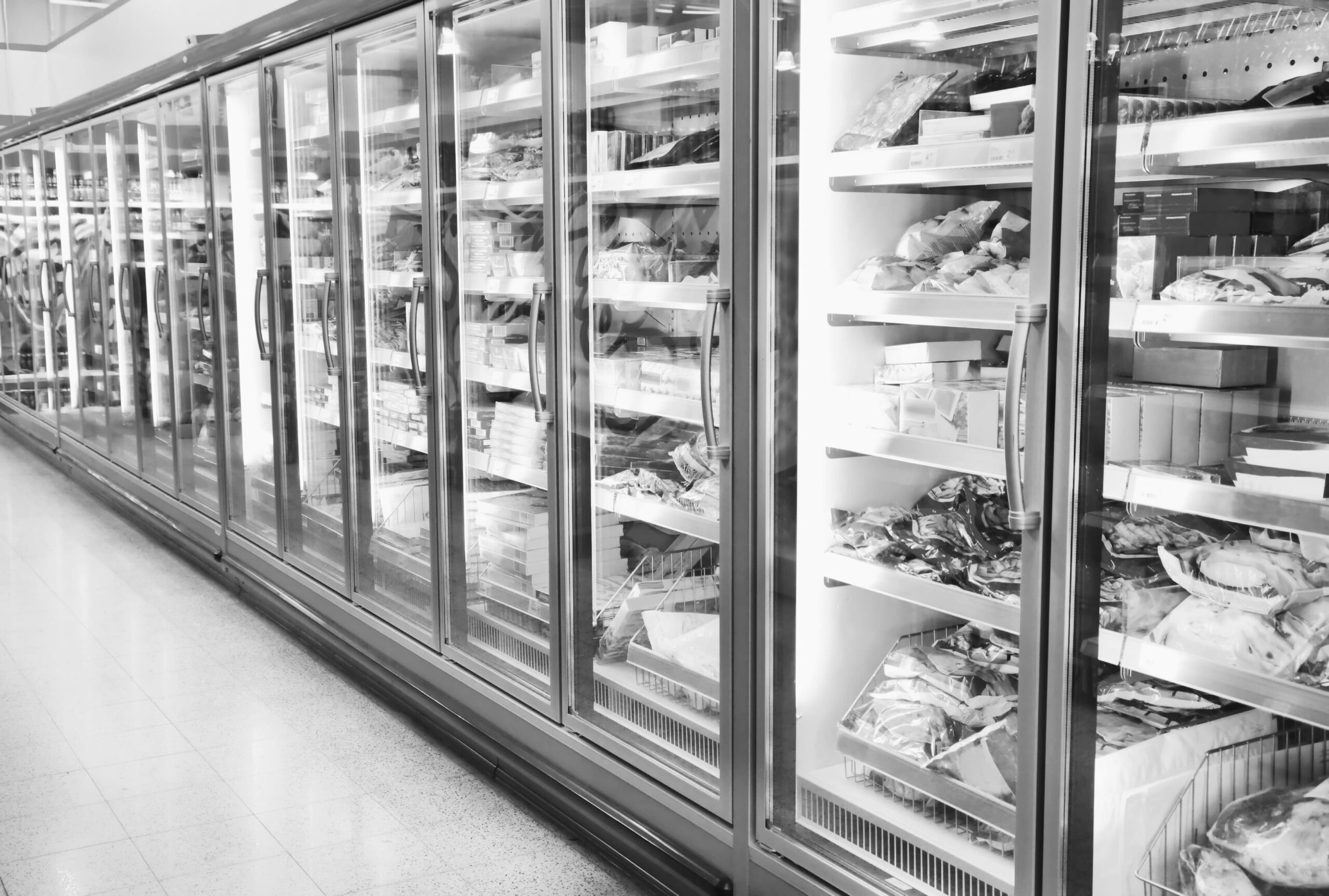 Black and white image of a supermarket frozen food aisle