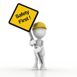 A 3D figure wearing a yellow hard hat holds a yellow "Safety First!" diamond-shaped sign.