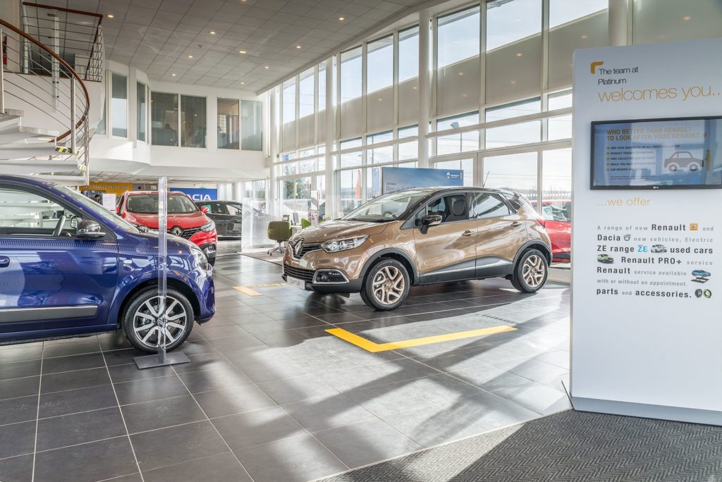 Display of cars showcased in a well-lit car showroom