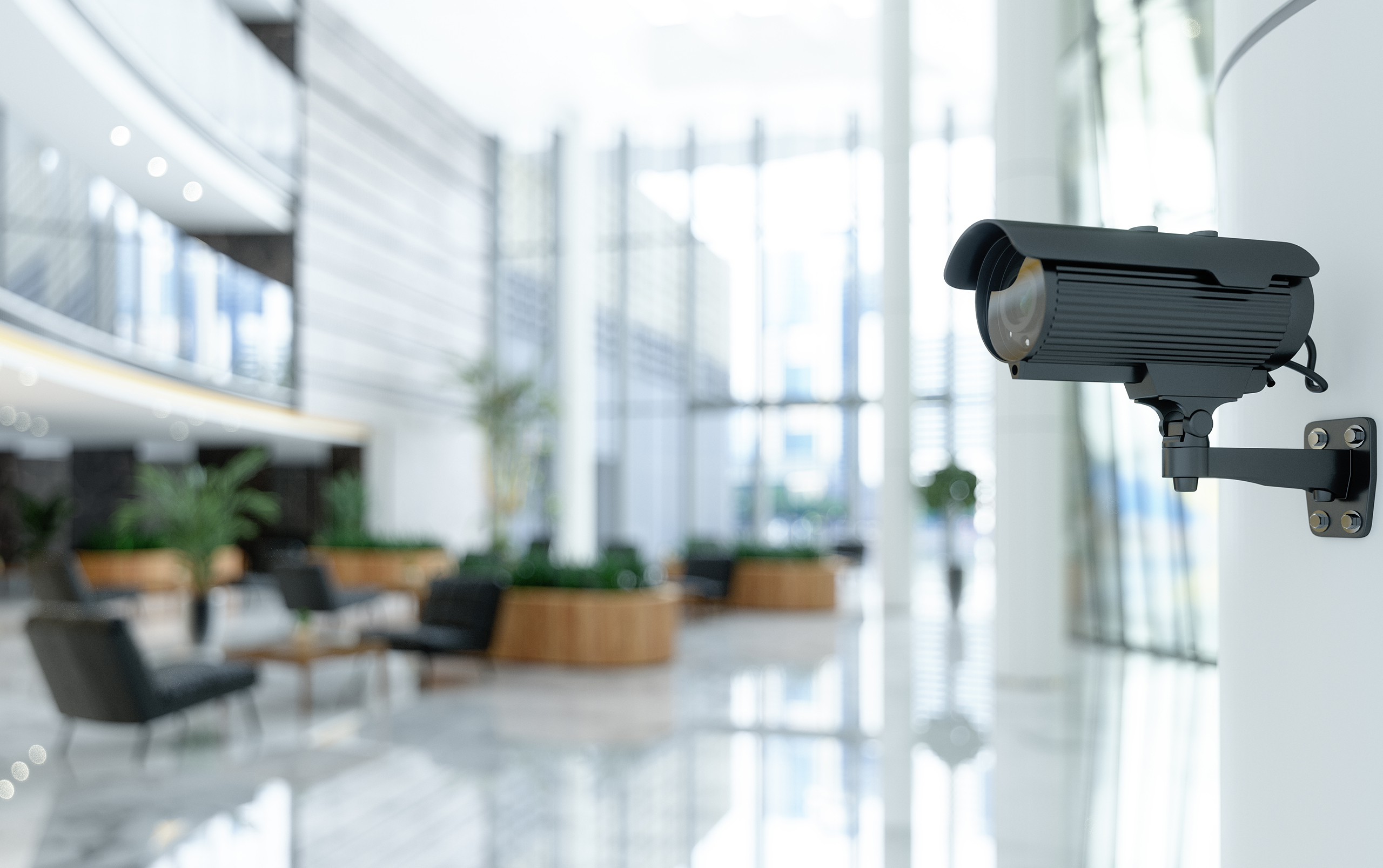 CCTV security camera installed in a modern building lobby.