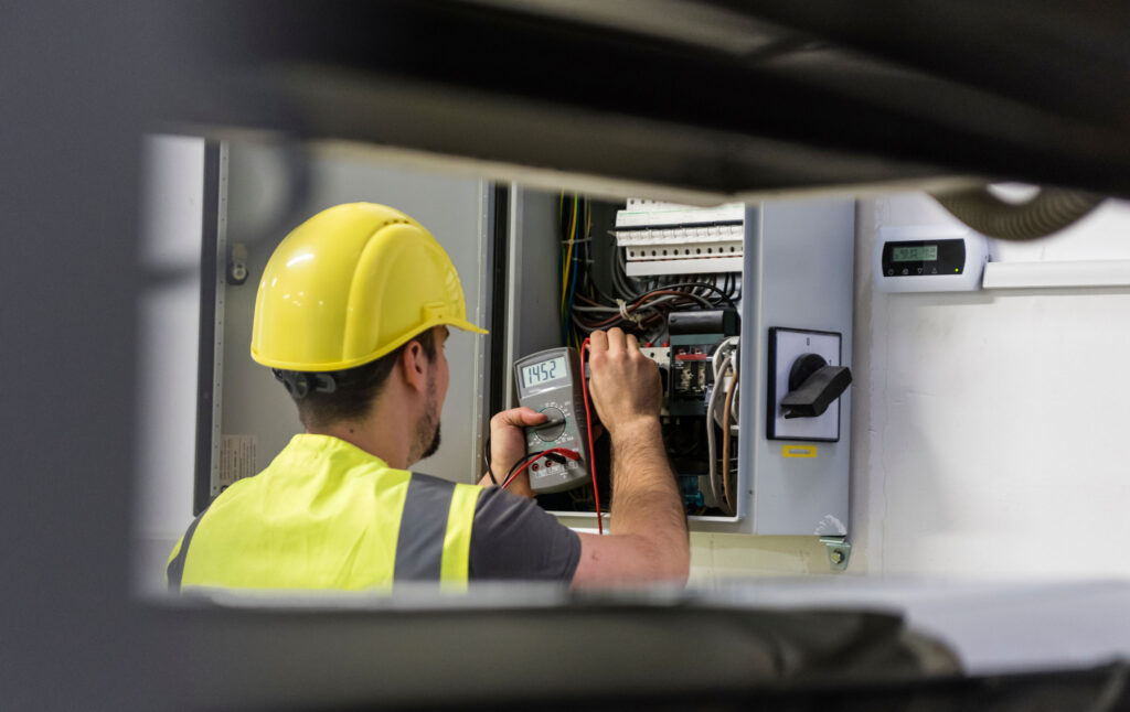 An electrician conducting routine maintenance and safety inspection